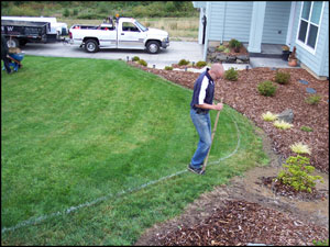 Using a tool to cut the sod into smaller pieces for removal.