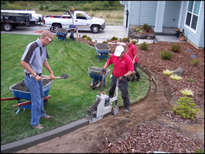 Extruding new concrete landscape curb in a continuous process.