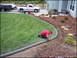 Putting the finishing touches on the new curb. 